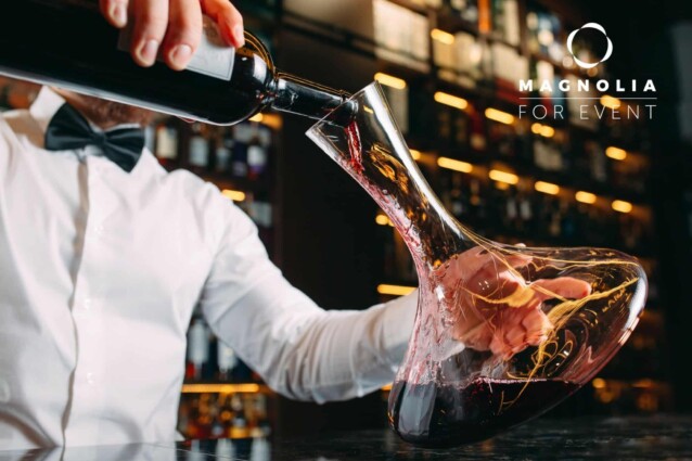 Young handsome man sommelier tasting red wine in cellar