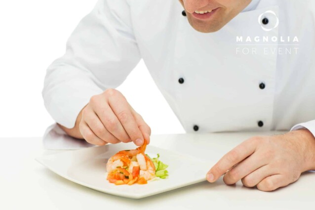 cooking, profession, haute cuisine, food and people concept - close up of happy male chef cook decorating dish