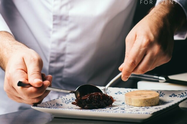 the chef decorates a plate of foie gras